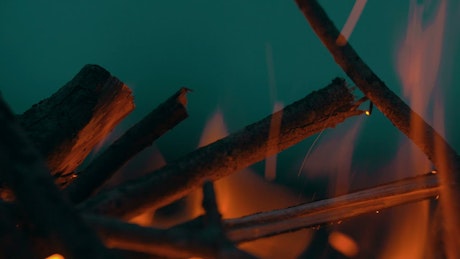 Bonfire burning against the night sky.
