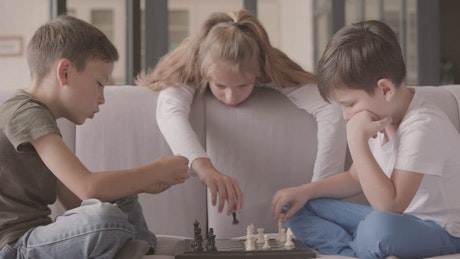 Bored kids playing chess.