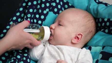 Bottle feeding a young baby
