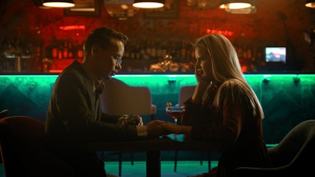 Boy and girl on a date in a bar.
