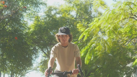 Boy doing a wheelie on a bike in a park