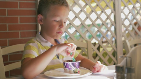 Boy eating chocolate ice cream