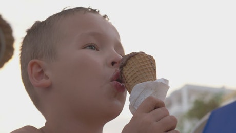 Boy enjoying a chocolate ice cream.