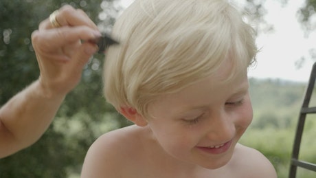 Boy having his hair cut.
