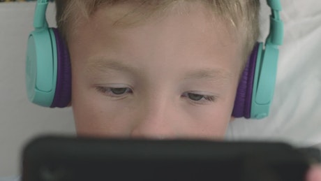 Boy playing games on a small tablet