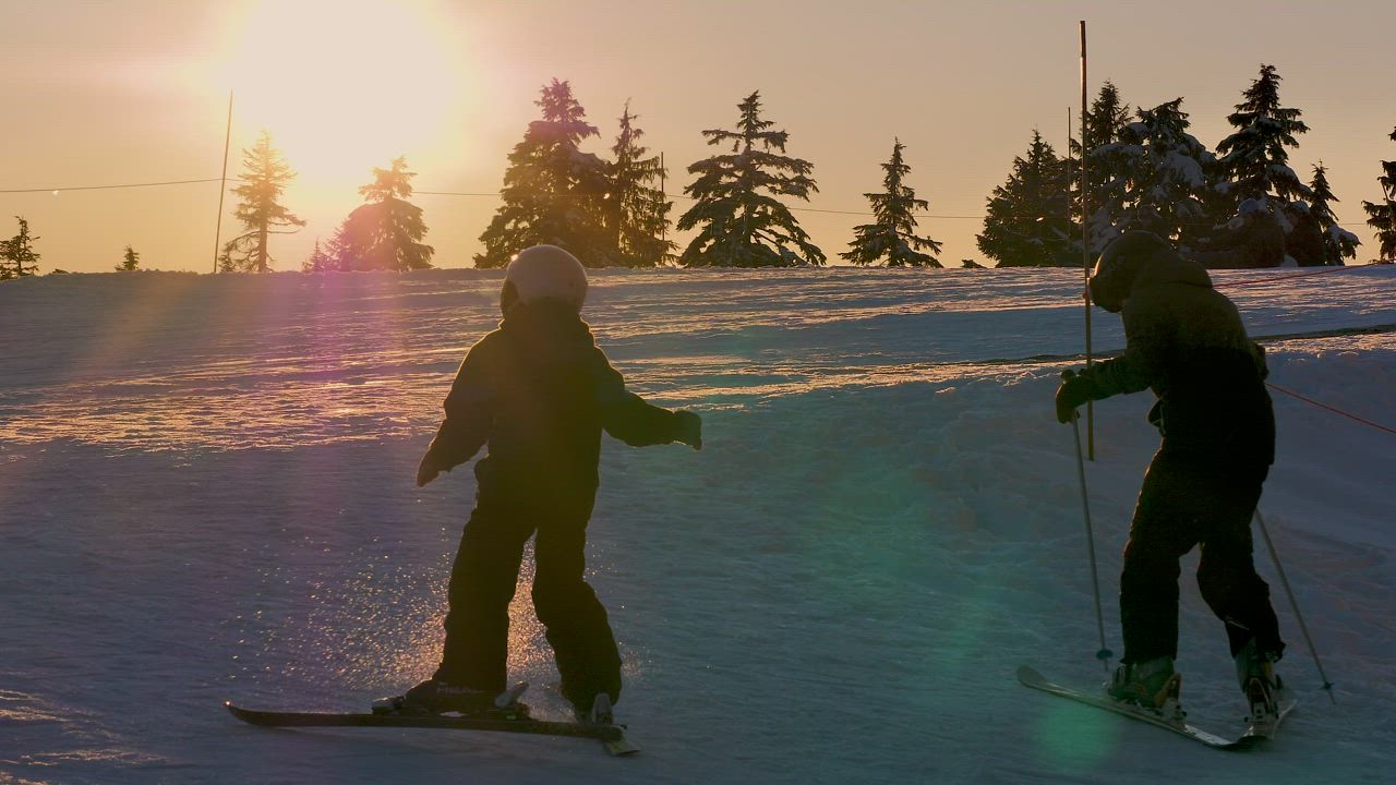 Boy skiing during sunrise - Free Stock Video - Mixkit
