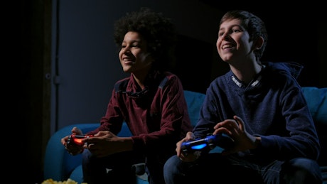 Boys playing video games at night