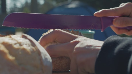 Breaking bread in a campsite.