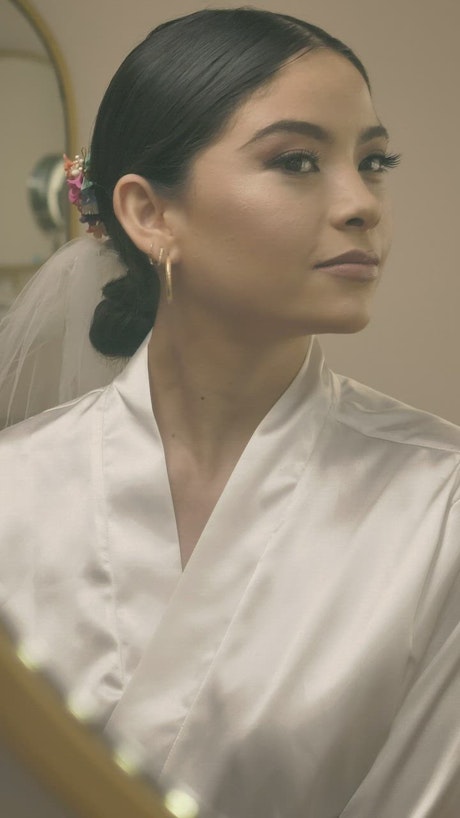 Bride admiring her makeup