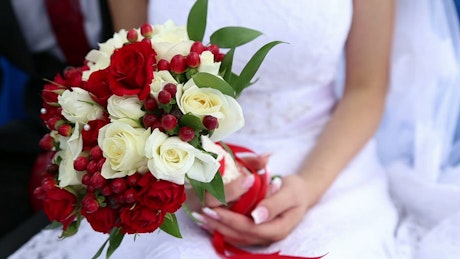 Bride holding a bouquet of wedding flowers.
