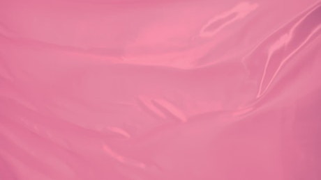 Bright pink fabric texture moving with the wind