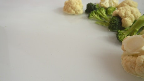 Broccoli splashing onto a table