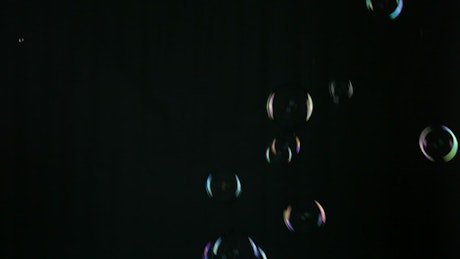 Bubbles falling on a black background.