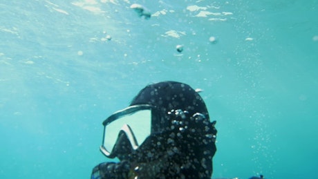 Bubbles rising from a diver