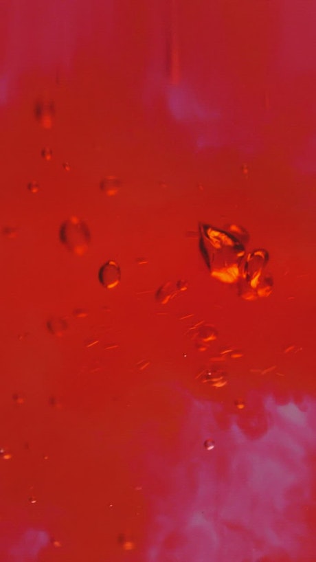 Bubbles under red water.