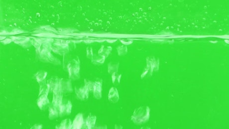 Bubbling water on a green background