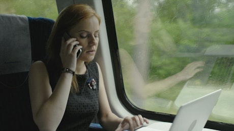 Business woman working while traveling.