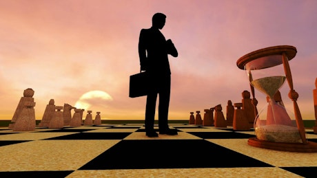 Businessman, hourglass and a giant chess.