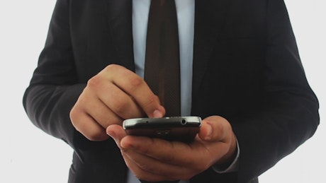 Businessman texting with a smartphone