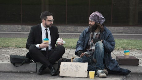 Businessman with homeless on the street.