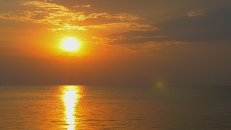 Calm ocean surface at sunset.