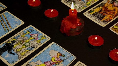 Candle melting between Tarot cards.