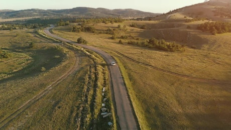 Car traveling in a countryside road, aerial shot