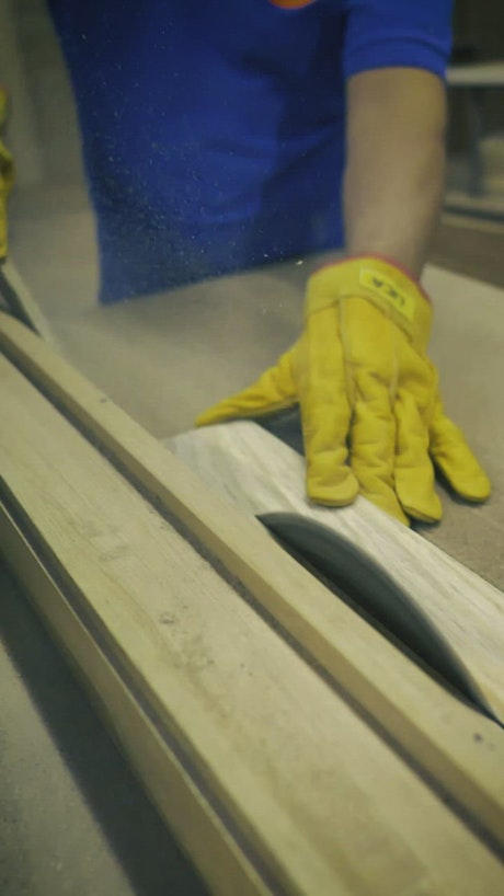 Carpenter slicing a wooden board in a close up shot