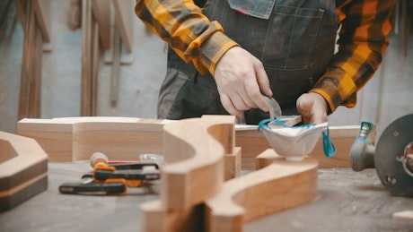 Carpenter working with wood in his workshop.