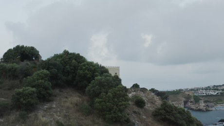Castle on a hill above the ocean.