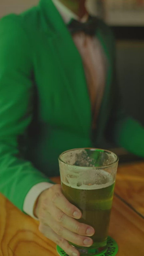 Cheerful man drinking a beer on st patrick's day.