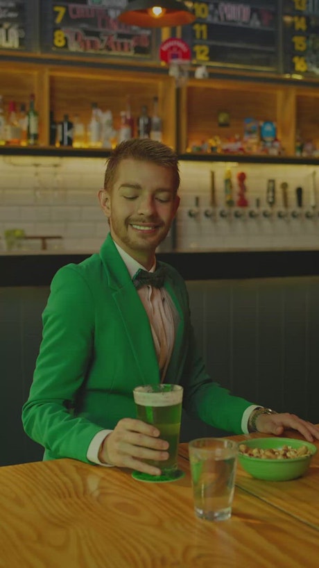 Cheerful man drinking in a bar on st patrick's day.