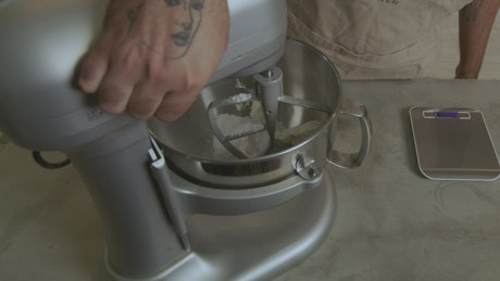 Chef beating a mixture in an electric mixer