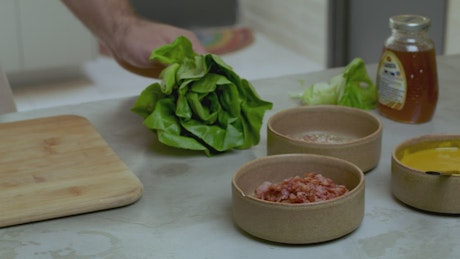 Chef chopping a lettuce.