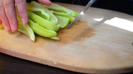 Chef cutting a green pepper