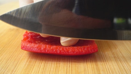 Chef cutting a pepper.
