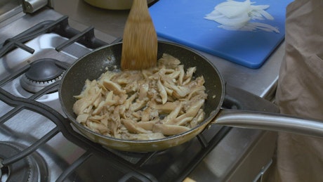 Chef frying mushrooms