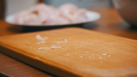 Chef pounding chicken meat on a board