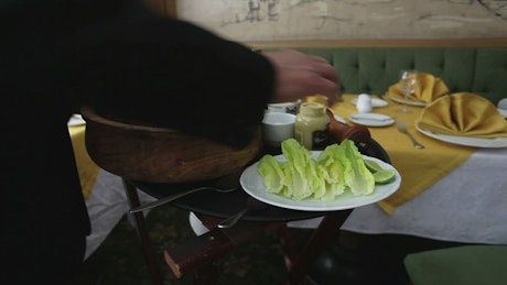 Chef preparing a salad in a restaurant.