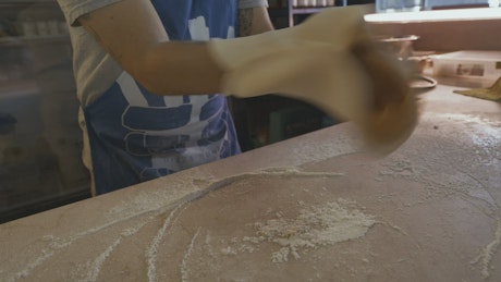 Chef's hands preparing dough.