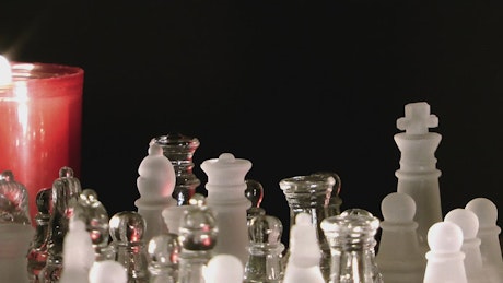Chess game lit by a candle