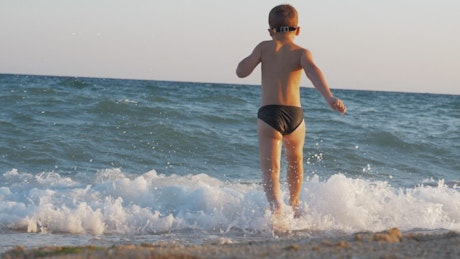 Child running into the sea