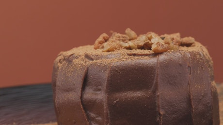 Chocolate cake with walnuts in a demonstration video.