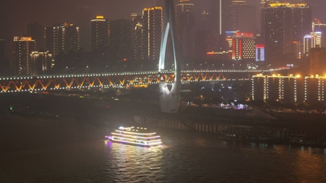 Chongqing Illuminated bridge and city buildings.