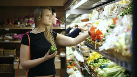 Choosing fruit and vegetables in a store.