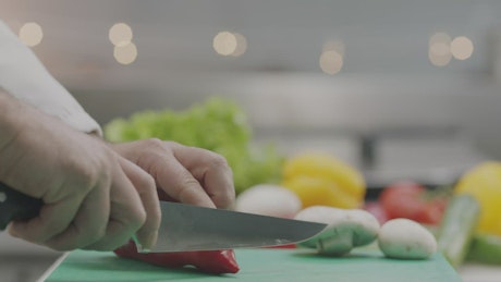 Chopping up vegetables in a kitchen.