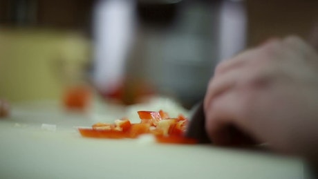Chopping vegetables preparing a recipe.