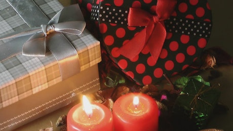 Christmas gifts and red candles, static shot