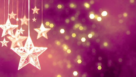 Christmas hanging stars with pink bokeh background.