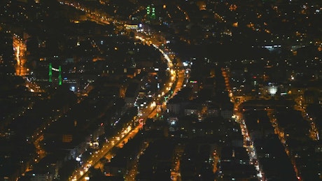 City lights at night seen from the sky.